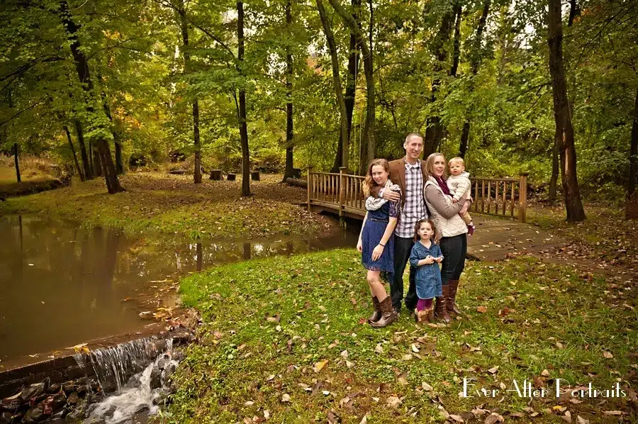 Parents with three children in the woods.